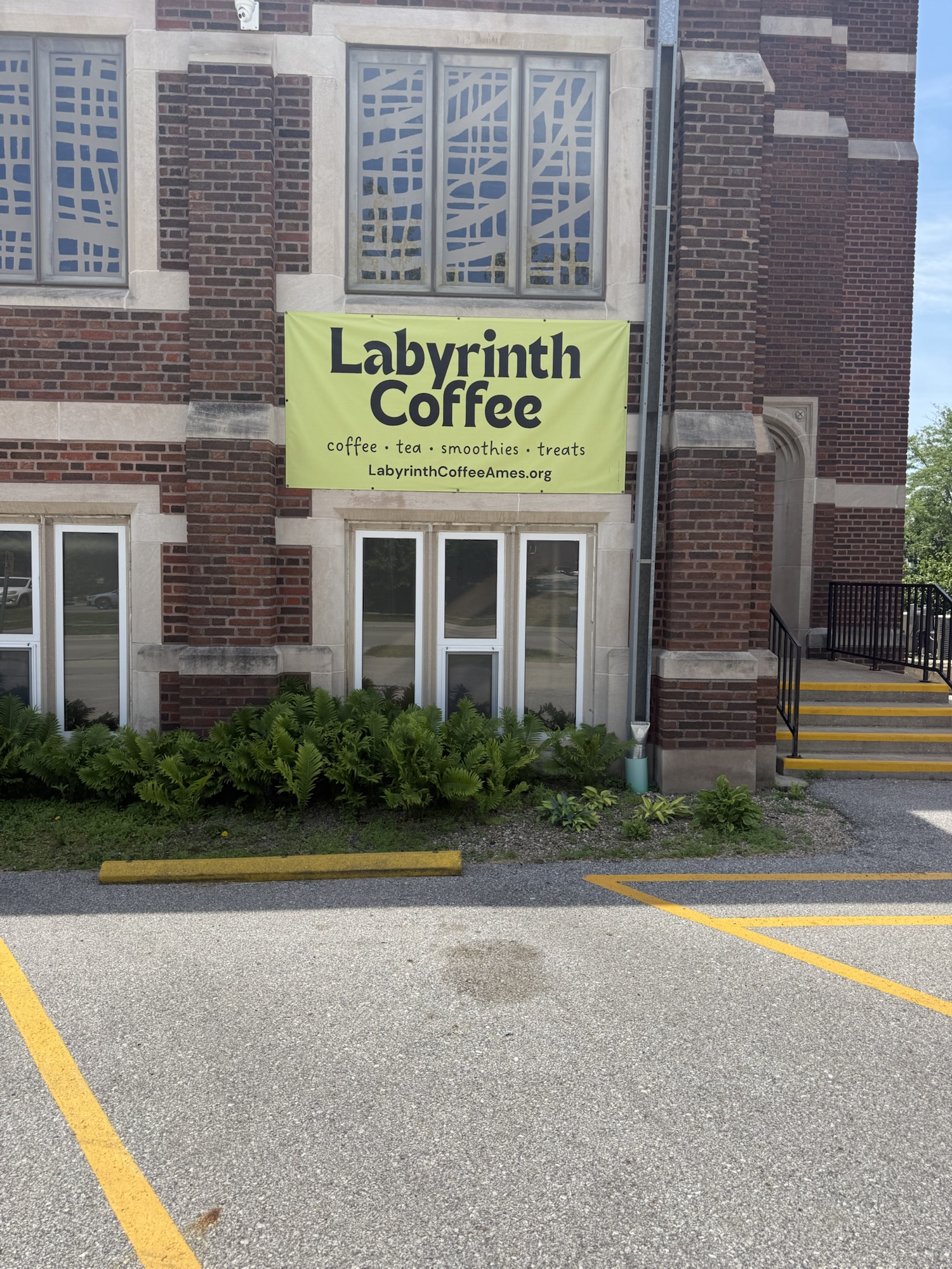 Green Labyrinth Coffee banner on the brick exterior of Collegiate Presbyterian Church in Ames Iowa